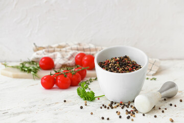 Mortar and pestle with peppercorns on light background
