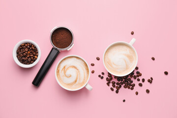 Cups of hot cappuccino on color background