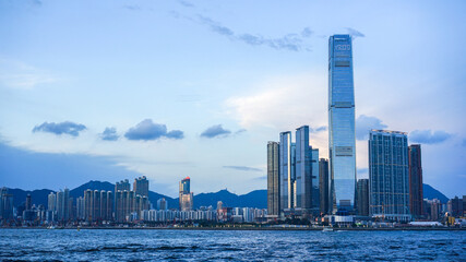 Hong Kong - June 25, 2016: city skyline view in Hong Kong at sunset, IFC building, blue sky, modern architecture, illustrative editorial