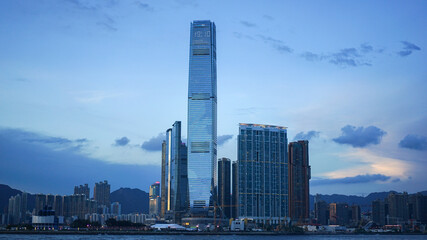 Fototapeta na wymiar Hong Kong - June 25, 2016: city skyline view in Hong Kong at sunset, IFC building, blue sky, modern architecture, illustrative editorial
