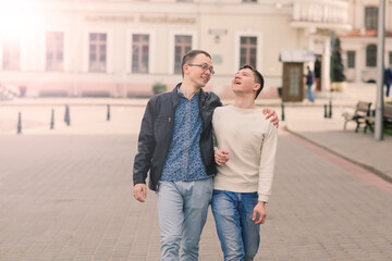 Young gay couple smiling happy and hugging at the city.