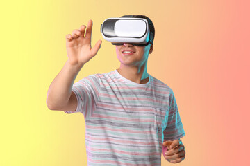 Young man with virtual reality glasses on color background