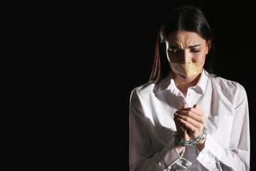 Female hostage on dark background