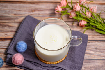 a cup of milk on wood background