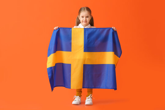 Little girl with the flag of Sweden on color background