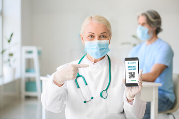 Doctor with electronic immune passport in clinic