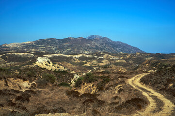 Fototapeta na wymiar Mountain landscape with dirt road on Kos island