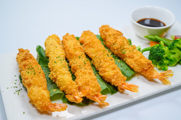 Fried shrimps and vegetables with white background