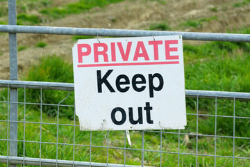 Private keep out sign on farm gate in the UK