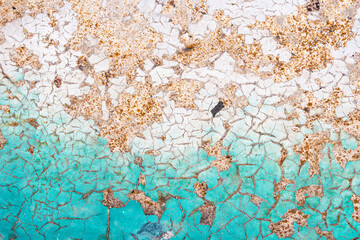 The texture of old rusty metal covered with cracked paint