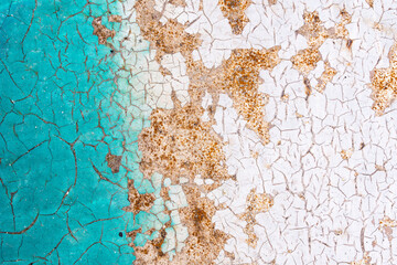 The texture of old rusty metal covered with cracked paint