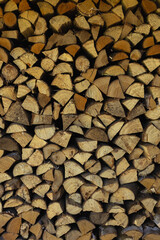 Stacked chopped firewood. Vertical orientation.