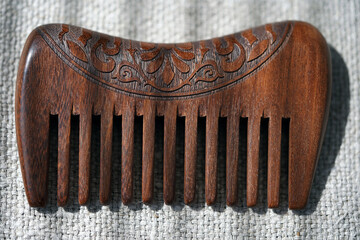 Wooden comb on canvas close-up. Macro. Hair Care Hygiene. Handmade woodwork. Salon. Hairdresser tools                              