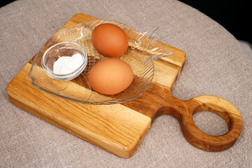 Two brown chicken eggs and salt top view. Eating raw foods. Proteins. Breakfast. Diet food                                