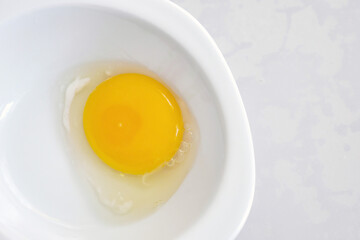 egg white and yolk in the plate separated from the shell,v