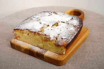 A piece of pie on a wooden plate. Homemade baking. Selective focus bread. Flour products. Cake. Biscuit. A portion. Dessert 