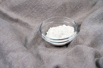 Flour in a round bowl. Baking ingredients. Bread. Glassware.                                
