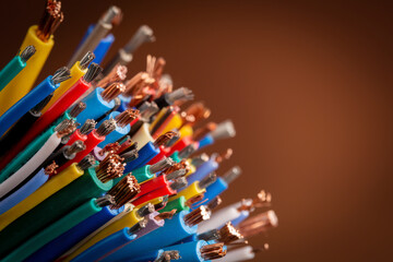 Close-up of colored electrical cable on brown with copy space, background