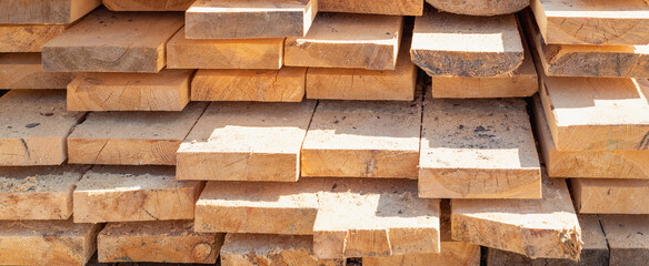 Wooden boards stacked in rows.