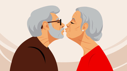 Mature couple kissing. Elderly man and old lady touch their lips to each other. Touching scene of love, tenderness, togetherness. Silhouette of lovers. Concept of Love and health in mature age.