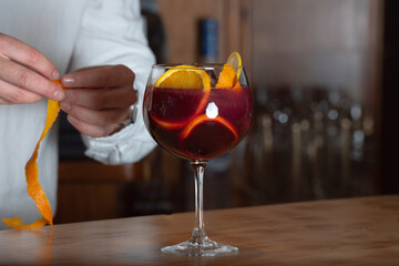 Sangria drink in glass isolated on a wooden table.