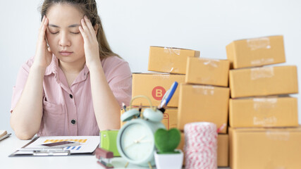 Young woman sitting on a desk is sad or depressed about a sales business, Anxiety and...