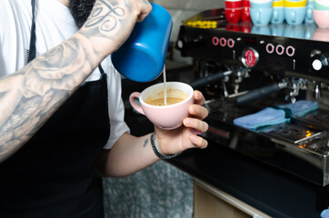 Barista making latte art coffee.