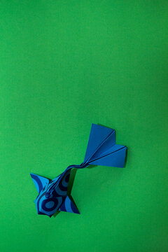 origami koi fish on a green background
