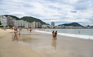   Citizens swim and sunbathe on the beach of Copacabana
