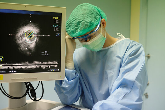 doctor used Intravascular ultrasound imaging (IVUS) machine and with emotional stress of overworked at cardiac catheterization laboratory room