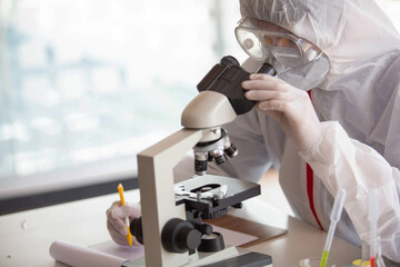 The doctor is testing a sample of biological tubes contaminated by Corona-virus Covid 19 and searching for a vaccine or Syrup against the virus. In the laboratory and film samples of infected lung