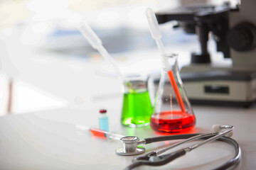 The doctor is testing a sample of biological tubes contaminated by Corona-virus Covid 19 and searching for a vaccine or Syrup against the virus. In the laboratory and film samples of infected lung
