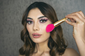 Obraz premium Closeup portrait of beautiful woman with bright make-up and pink lips. Attractive model with a pink lipstick.