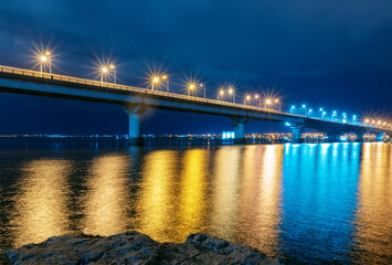 Night city view, luminous buildings and bridge. Ukraine. Nikolaev.