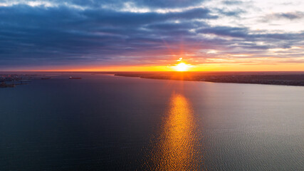 Shipping cargo to harbor by ship. Water transport International. Aerial view at sunset