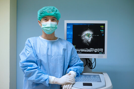 Doctor wears sterile uniform and uses Intravascular ultrasound imaging (IVUS) machine at cardiac catheterization laboratory room