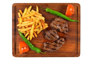 grilled entrecote and french fries on wooden plate. grilled meat dish. white background. Barbecue dry aged entrecote menu photo top view