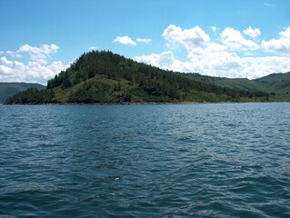 mountain with green plants and blue sea blue sky