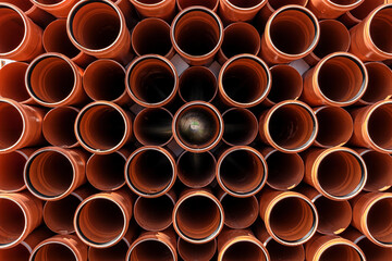 Stack of Orange pipe made of polyvinyl chloride