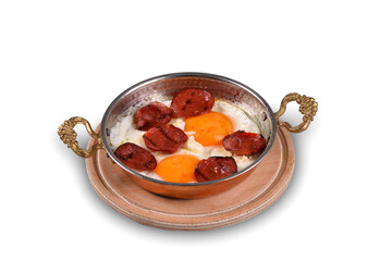 Turkish breakfast with eggs in a copper pan. Eggs with sausage in copper pan, white background close up. traditional turkish breakfast. (Turkish Sosis) - obrazy, fototapety, plakaty