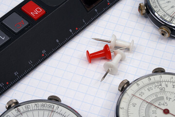 Logarithmic ruler closeup and colorful pencils on a white background. Vintage antique round slide ruler Calculator, felt-tip pens, office, calculating device. Maths. Mathematical. Measuring instrument