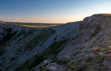 Pid to the surrounding mountains from the lower plateau of Chatyr-Dag in Crimea in the light of the setting sun.