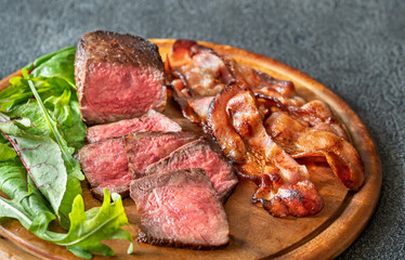 Beef steak with fried bacon