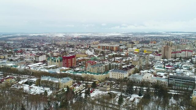 Flight over the winter town in the snow