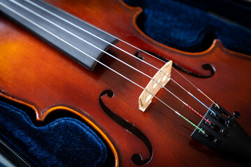 Fototapeta premium A close up of a syphony violin set against a black background