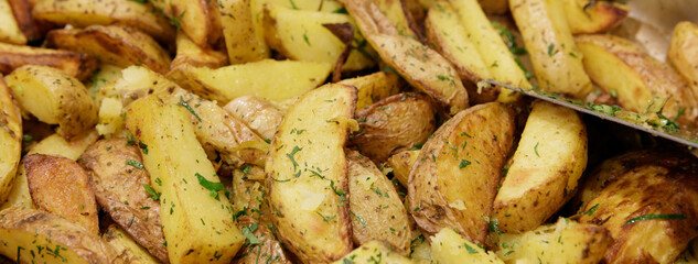 beautiful potatoes baked with wedges in the oven with fragrant herbs. selective focus .High quality photo