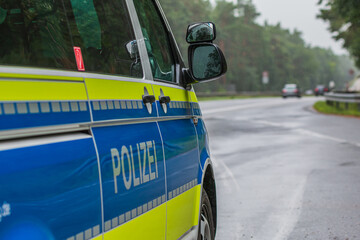 Side view from the passenger side of a German police car with the highway in the background. Police...
