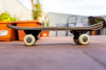 View of an old skateboard on the terrace of the house. Selective focus