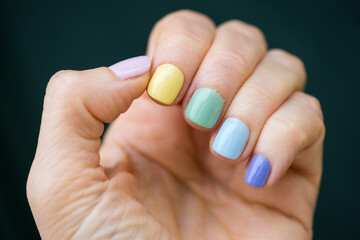 Hand with rainbow pastel manicure, beauty nails