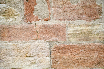 Stone wall bricked with strong structure, photographed in daylight